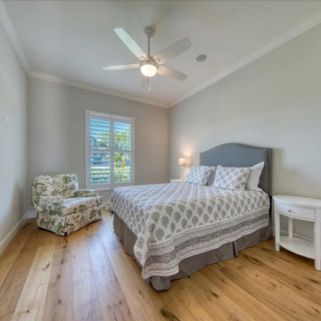 Soft Neutral Girls Bedroom With Accent Chair and Abundant Light