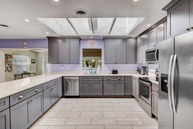 Example of an island style kitchen design in New York