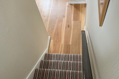 Design ideas for a mid-sized contemporary hallway in Manchester with beige walls, brown floor and vinyl floors.