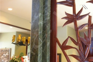 Inspiration for a large tropical green tile and stone slab bathroom remodel in Hawaii with dark wood cabinets, an undermount tub, a vessel sink, granite countertops and green countertops