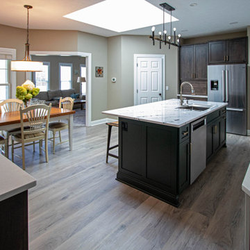 3 Finishes on Kitchen Cabinetry with Galley Workstation in Island and Wine Bar