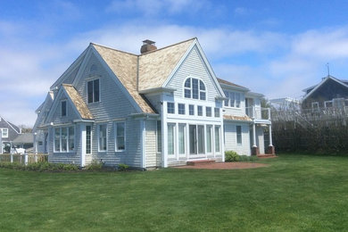 Beach style gray two-story wood exterior home photo in Other with a shingle roof