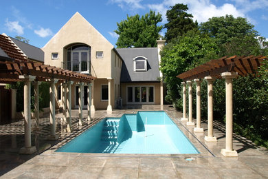 Design ideas for a large contemporary backyard rectangular pool in Christchurch with tile.