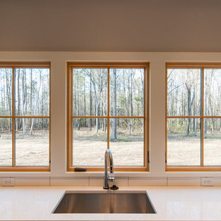 Mid-sized farmhouse kitchen pantry inspiration - Inspiration for a mid-sized cottage l-shaped concrete floor and multicolored floor kitchen pantry remodel in Richmond with an undermount sink, flat-panel cabinets, light wood cabinets, granite countertops, white backsplash, porcelain backsplash, stainless steel appliances and an island