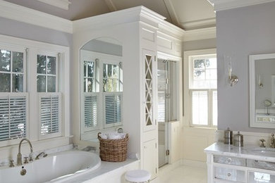 Example of a mid-sized classic master white tile and marble tile ceramic tile and white floor bathroom design in Miami with glass-front cabinets, white cabinets, gray walls, an undermount sink, marble countertops and a hinged shower door