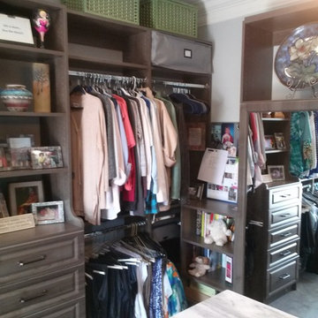 Beautiful Master Closet with island and unique jewelry cabinet