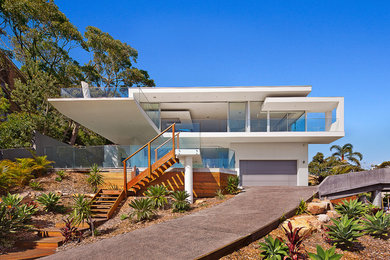 Inspiration for a contemporary two-storey white exterior in Sydney with a flat roof.