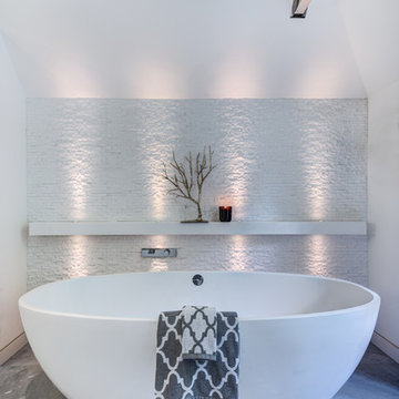Views of this beautiful stand alone soaker tub in this modern bathroom