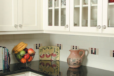 Mid-sized elegant kitchen photo in Portland with shaker cabinets, white cabinets and an island