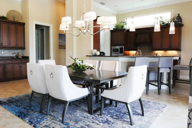 Example of a mid-sized transitional ceramic tile and brown floor kitchen/dining room combo design in Miami with beige walls and no fireplace