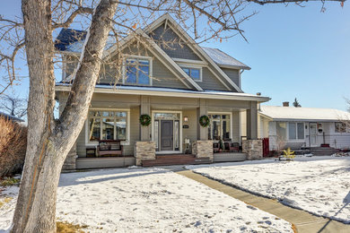 Mid-sized arts and crafts beige two-story concrete fiberboard gable roof photo in Calgary