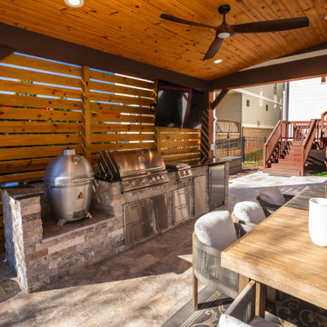 Covered Outdoor Kitchen with Wood Slat Wall and Built-In Grill Station