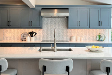 Example of a transitional kitchen design in New York with shaker cabinets, blue cabinets and stainless steel appliances