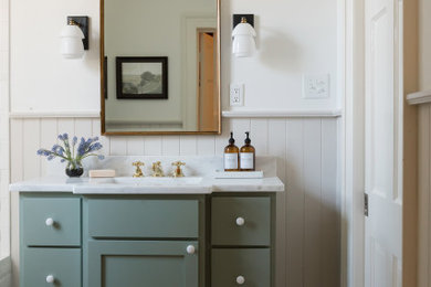 Inspiration for a transitional mosaic tile floor, multicolored floor, single-sink and wainscoting bathroom remodel in Jackson with shaker cabinets, green cabinets, white walls, an undermount sink, white countertops and a freestanding vanity