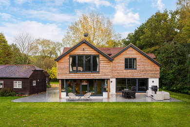 Design ideas for a classic rear house exterior in Hampshire with wood cladding and shiplap cladding.