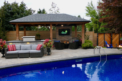 Design ideas for a large contemporary backyard stone landscaping in Toronto.