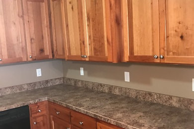 Mid-sized trendy galley dark wood floor and brown floor eat-in kitchen photo in Other with an undermount sink, shaker cabinets, white cabinets, quartzite countertops, white backsplash, ceramic backsplash and black appliances