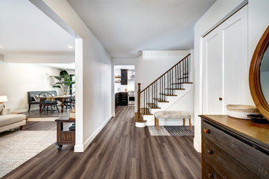 Inspiration for a timeless vinyl floor and brown floor foyer remodel in New York with white walls