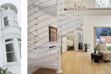 Example of a large transitional spiral metal railing staircase design in Los Angeles