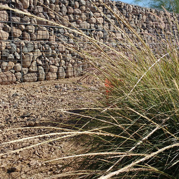 Backyard wall/fence and retaining wall in front supporting hillside construction