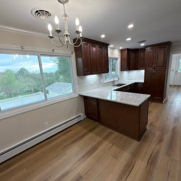 USCD cabinetry accompanied granite countertops, porcelain tile backsplash and Ca