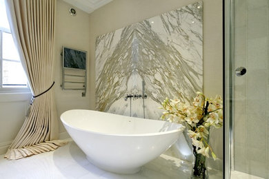 Contemporary bathroom in Essex with a freestanding tub and white walls.
