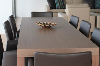 This is an example of a mid-sized modern kitchen/dining combo in Brisbane with light hardwood floors.