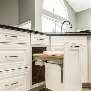 Large traditional kitchen pantry remodeling - Kitchen pantry - large traditional u-shaped porcelain floor kitchen pantry idea in Orlando with an undermount sink, raised-panel cabinets, white cabinets, granite countertops, green backsplash, mosaic tile backsplash, stainless steel appliances and a peninsula