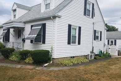 Cottage porch idea in Providence with a roof extension