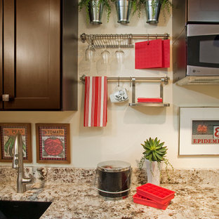 Выдающиеся фото от архитекторов и дизайнеров интерьера: маленькая параллельная кухня в современном стиле с обеденным столом, одинарной раковиной, фасадами в стиле шейкер, темными деревянными фасадами, столешницей из гранита, бежевым фартуком, техникой из нержавеющей стали, ковровым покрытием и бежевым полом