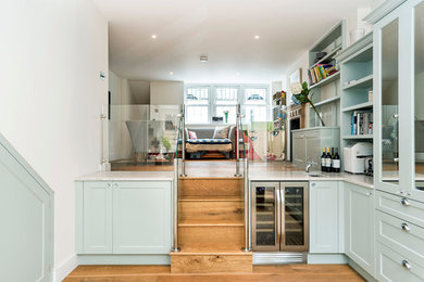 Photo of a classic wood straight staircase in London with wood risers.