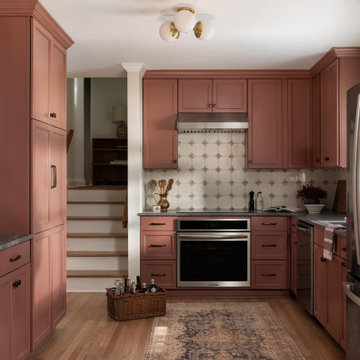 Portuguese-Inspired Modern Kitchen with Terracotta Cabinets and Blue Tile