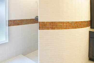 Example of a mid-sized trendy master orange tile and glass tile travertine floor doorless shower design in Sacramento with an undermount sink, glass-front cabinets, distressed cabinets, granite countertops, a two-piece toilet and beige walls