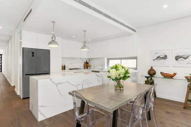 Inspiration for a contemporary kitchen/dining combo in Sydney with brown floor, white walls and dark hardwood floors.