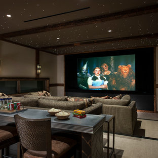 Example of a southwest enclosed carpeted and beige floor home theater design in Phoenix with white walls and a projector screen