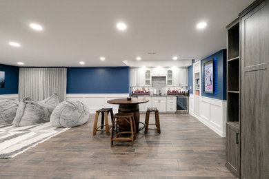 Basement - large transitional dark wood floor and brown floor basement idea in Philadelphia with a bar and blue walls