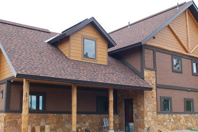 Inspiration for a large timeless brown two-story mixed siding exterior home remodel in Denver