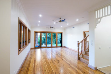Photo of a large traditional living room in Sydney with medium hardwood floors.