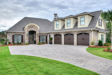 Example of a transitional beige two-story brick house exterior design in Other with a shingle roof