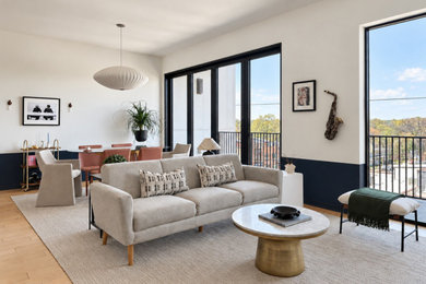 Mid-sized trendy open concept light wood floor living room photo in Raleigh with white walls