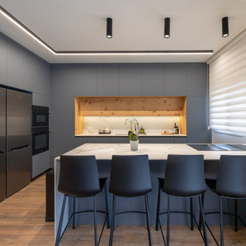 Modern kitchen with grey cabinets and marble island