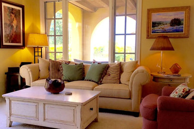 Inspiration for a mid-sized mediterranean open concept carpeted and brown floor living room remodel in Orange County with yellow walls