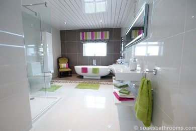 Large contemporary family bathroom with a freestanding bath, a corner shower, a two-piece toilet, beige tiles, porcelain tiles, yellow walls, porcelain flooring and a console sink.