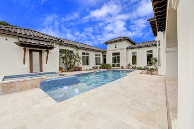 Inspiration for a large mediterranean backyard stamped concrete and rectangular lap hot tub remodel in Austin