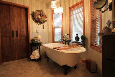 This is an example of a large traditional master bathroom in Seattle with shaker cabinets, dark wood cabinets, a freestanding tub, a corner shower, a two-piece toilet, black tile, ceramic tile, brown walls, ceramic floors, a drop-in sink and granite benchtops.