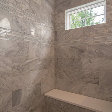 Traditional master bath utilizing frosted and clear glass to allow for needed pr