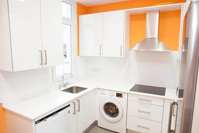 This is an example of a mid-sized contemporary u-shaped separate kitchen in Bilbao with flat-panel cabinets, no island, white cabinets, ceramic floors and grey floor.