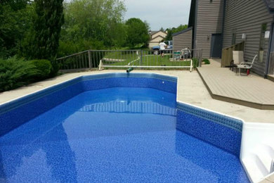Large backyard pool photo in Milwaukee