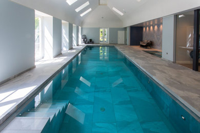 This is an example of a medium sized contemporary swimming pool in London.