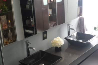 Inspiration for a contemporary gray tile and ceramic tile ceramic tile double shower remodel in Los Angeles with a vessel sink, flat-panel cabinets, dark wood cabinets, quartz countertops, a two-piece toilet and blue walls